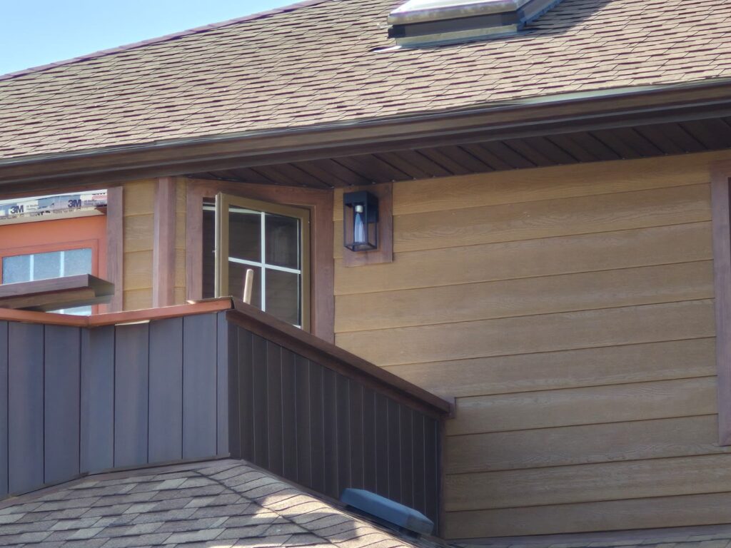 After - wood patterned seamless gutters (eavestrough), cladding, soffit and fascia installation in Strathmore